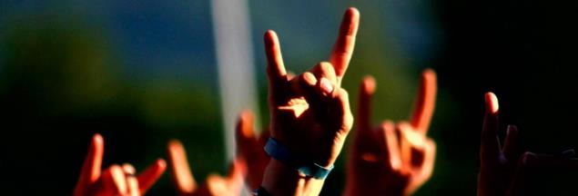 hands making 'it rocks' signs at festival