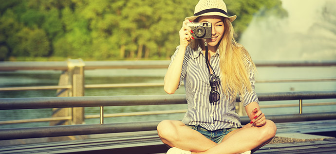 Portrait of Young Hipster Girl Making Photo with Vintage Camera. Modern Youth Lifestyle Concept. Toned Instagram Styled Photo.