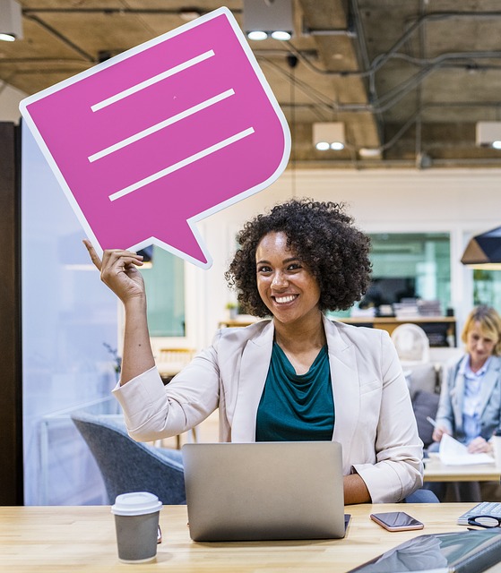 A business woman holds a chat bubble