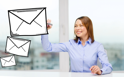 Smiling Businesswoman Drawing Envelope on Virtual Screen