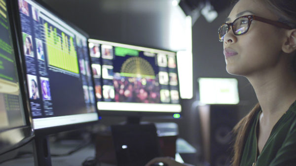 Woman looking at data on computer screens- Michelle Pittman blog- PR and AI