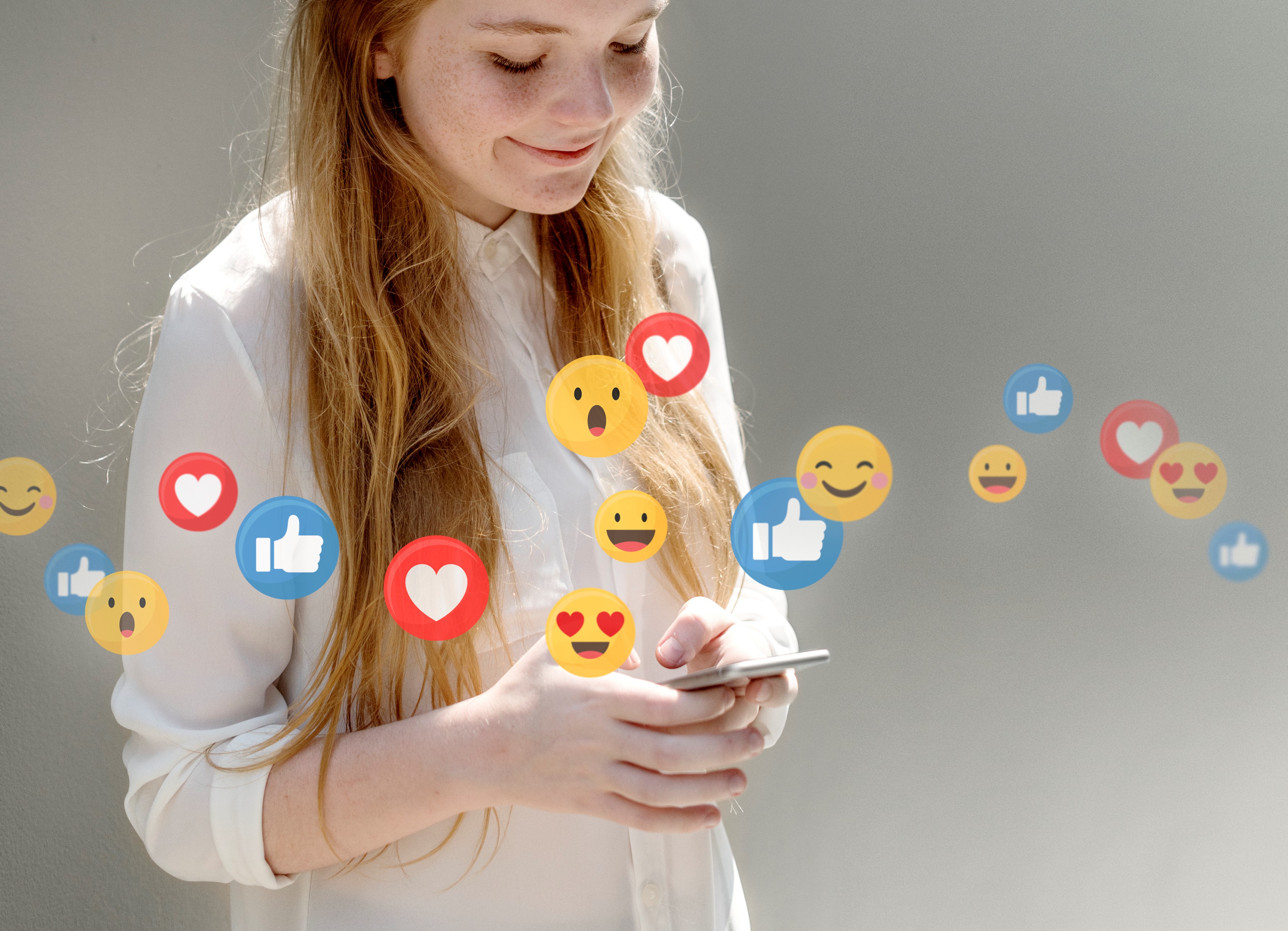 Woman looking at phone engaging with social media content.
