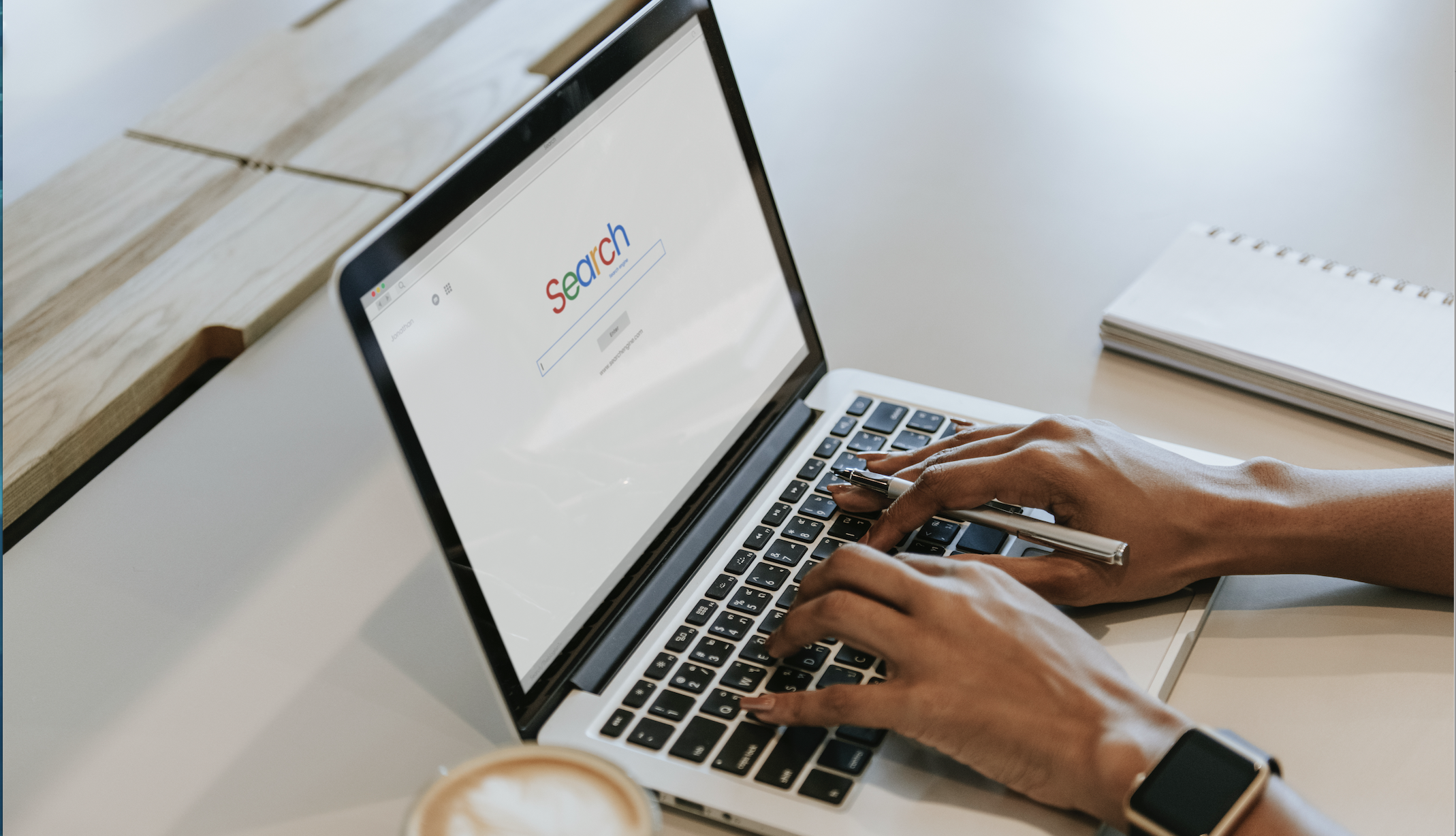 A persons hands conducts a search on a computer scree. This is to show that people will make decisions based off the first page of Google results. 