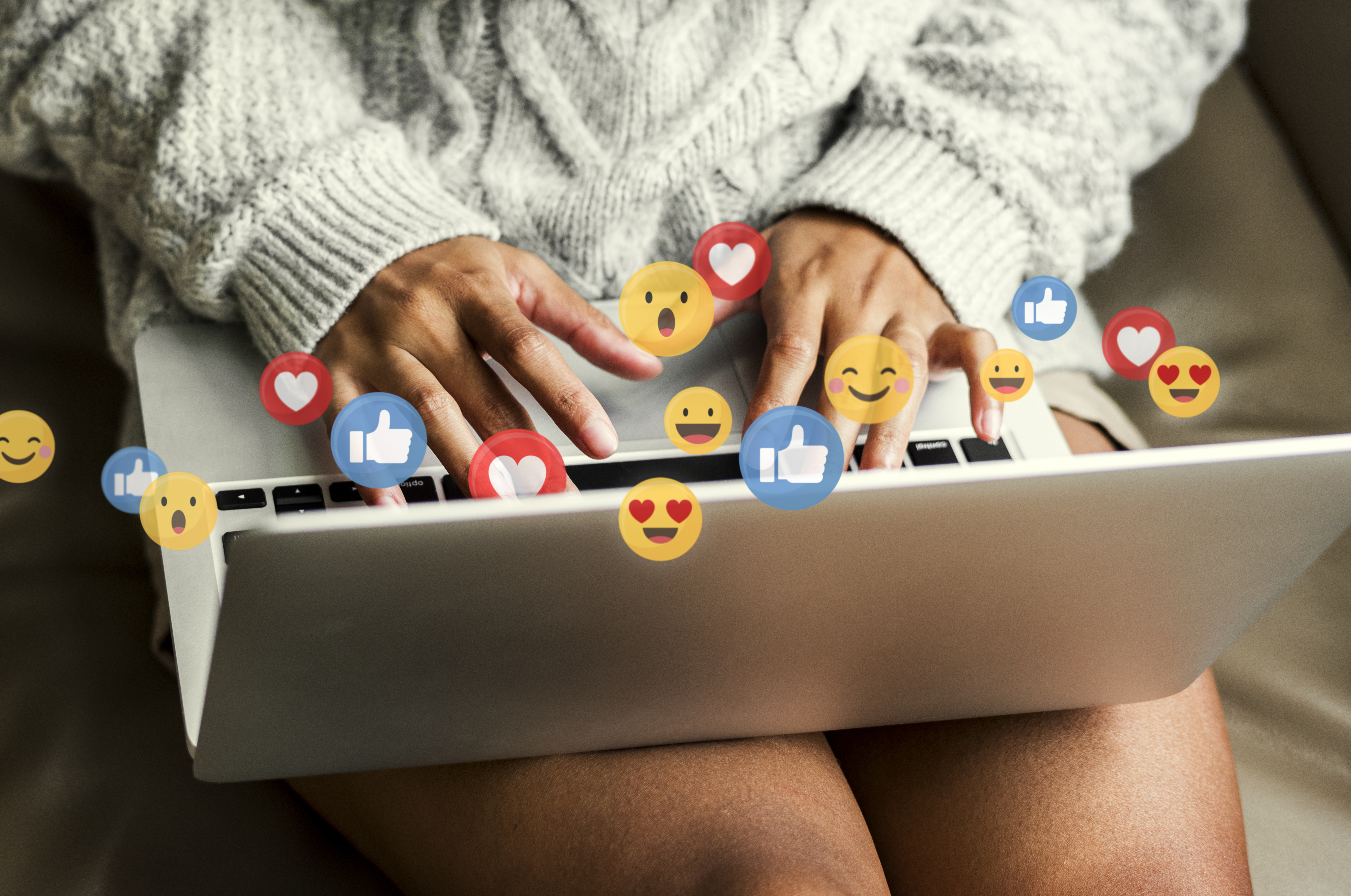 Marketing on TikTok - Person holding laptop and recieving tons of likes on their content. 