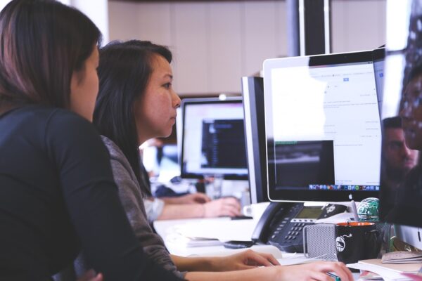 Marketing professionals analyzing data at a desktop computer
