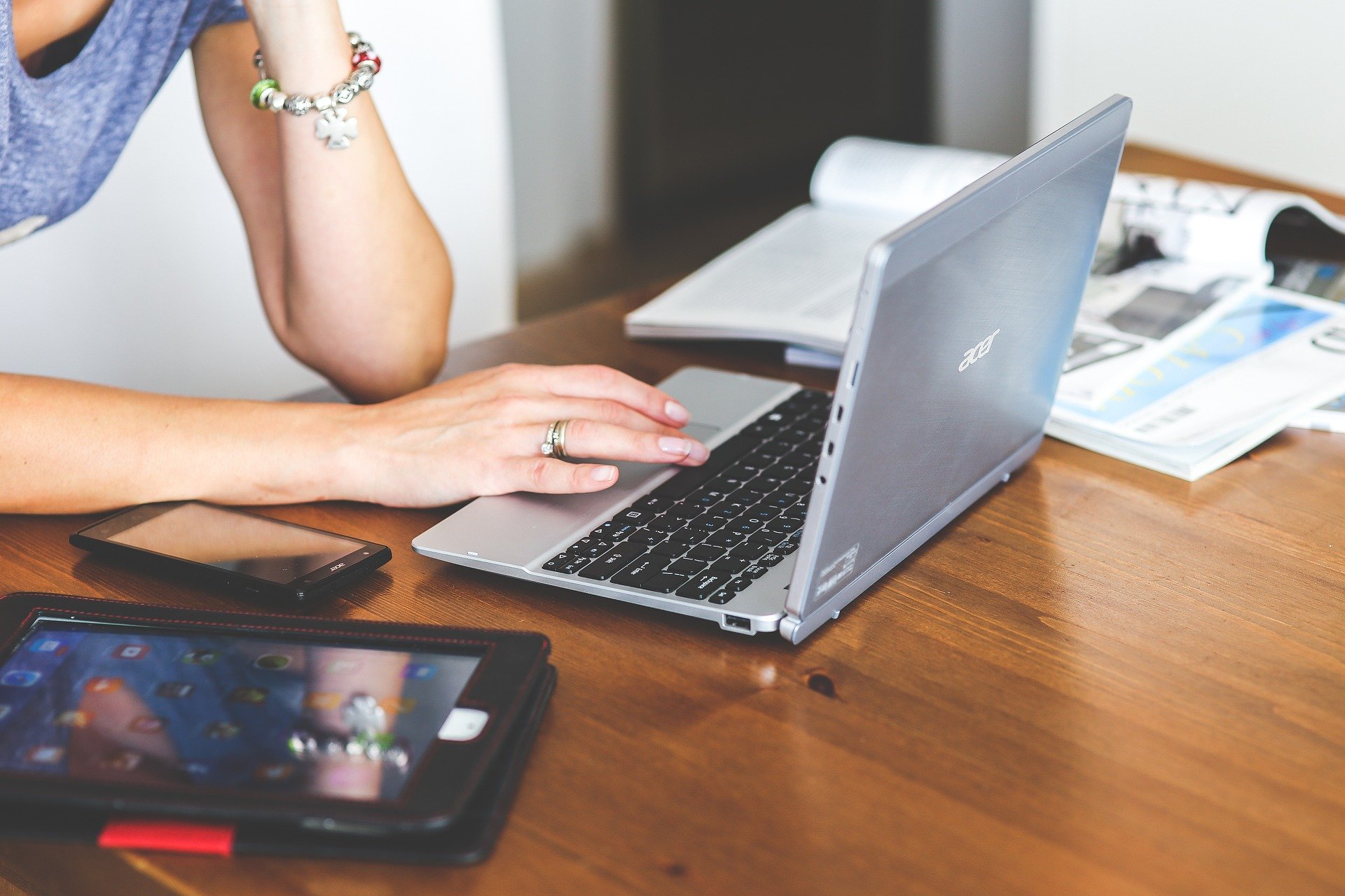 A woman scrolling on a laptop.