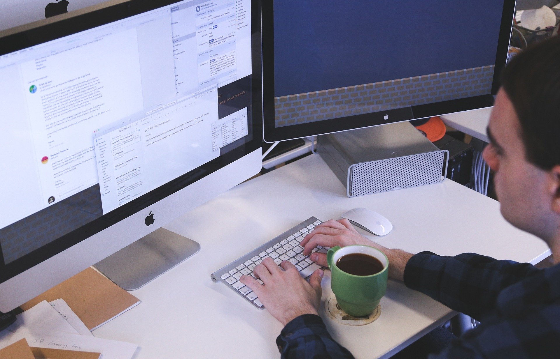 A man typing an email response.