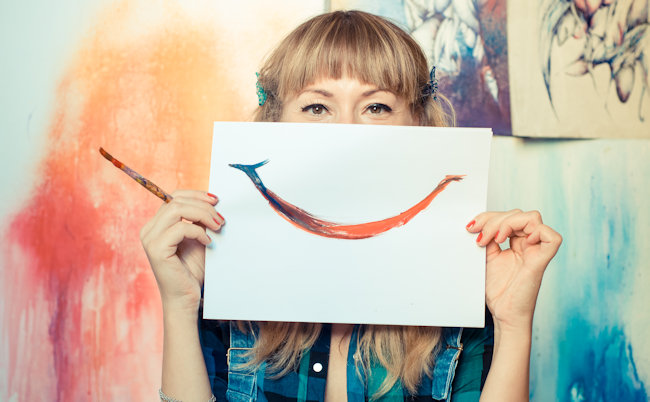 beautiful blonde woman painter smiling in her studio