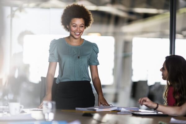 smiling businesswoman sharing ideas in meeting