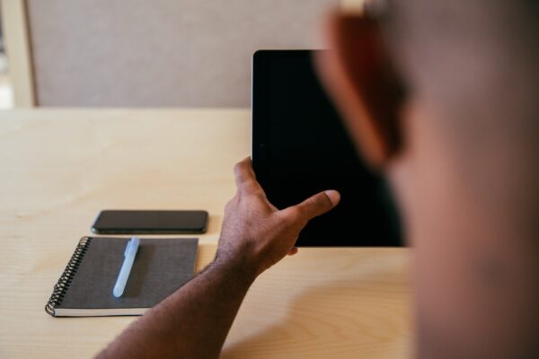 Man holding tablet.