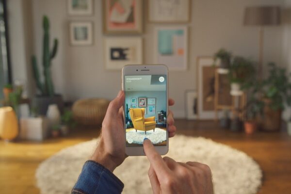 A man is visualizing a product via his smartphone