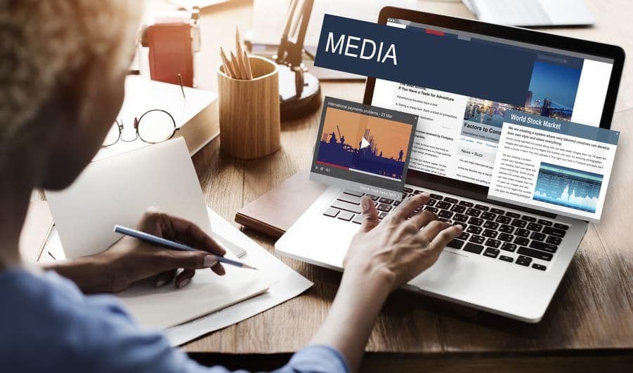 Someone typing on a computer, the word media