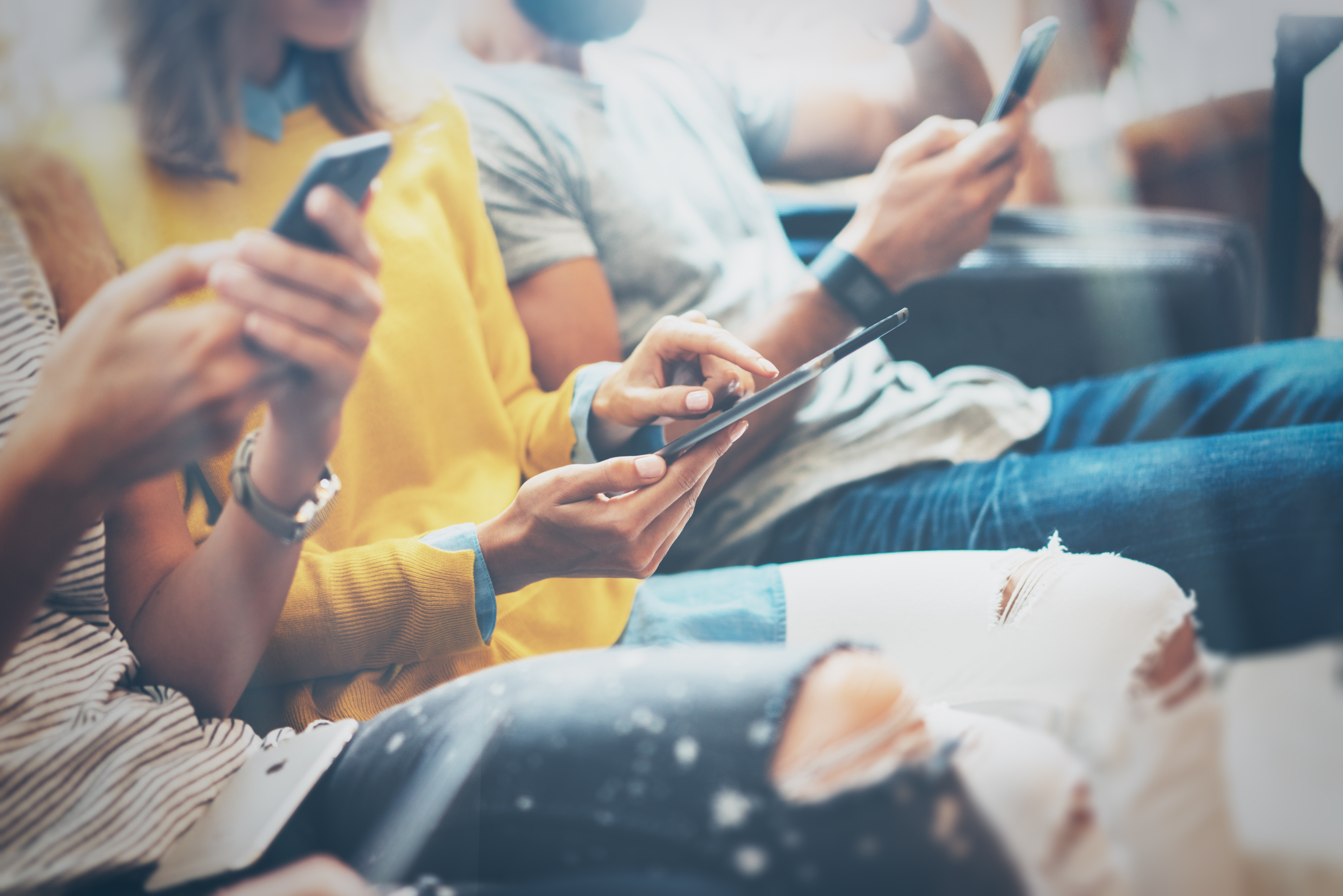 a group of people on their phones engaging with content marketing