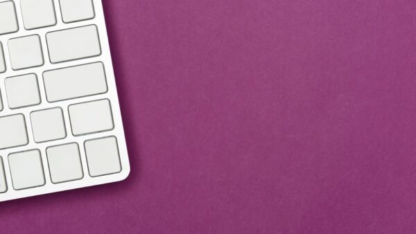 white keyboard on purple background