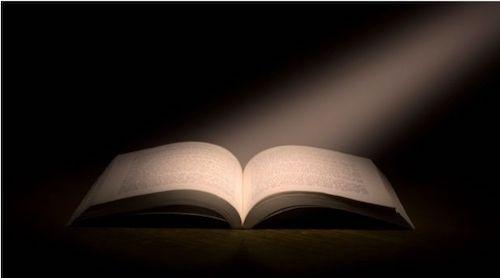 year-in-review email examples - yearbook with light shining on it