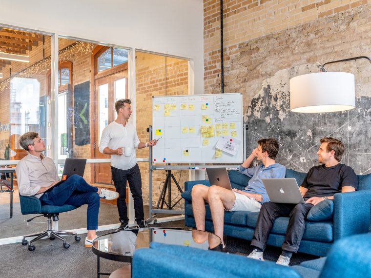 4 men looking at a whiteboard