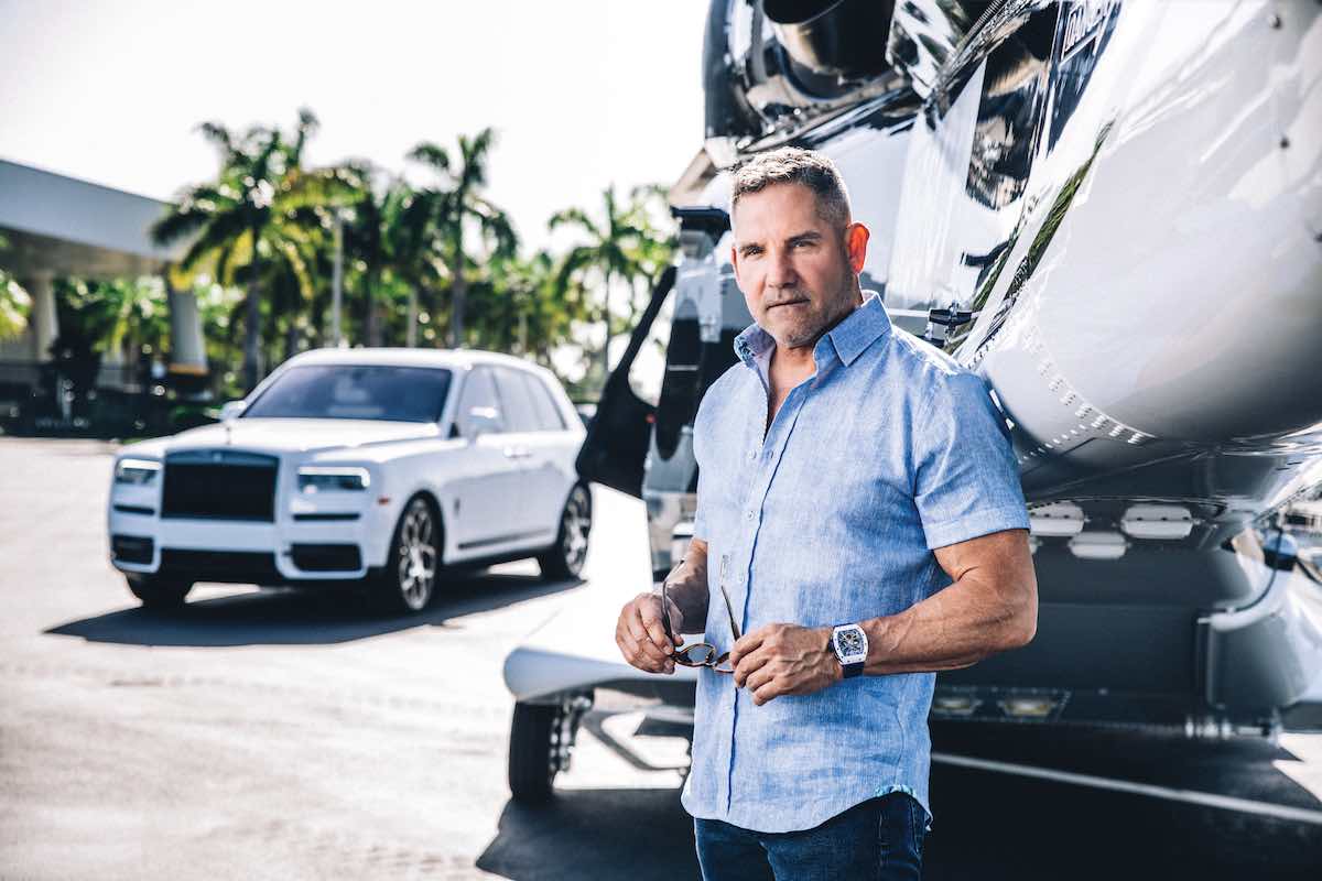grant cardone in front of a plane and rolls royce
