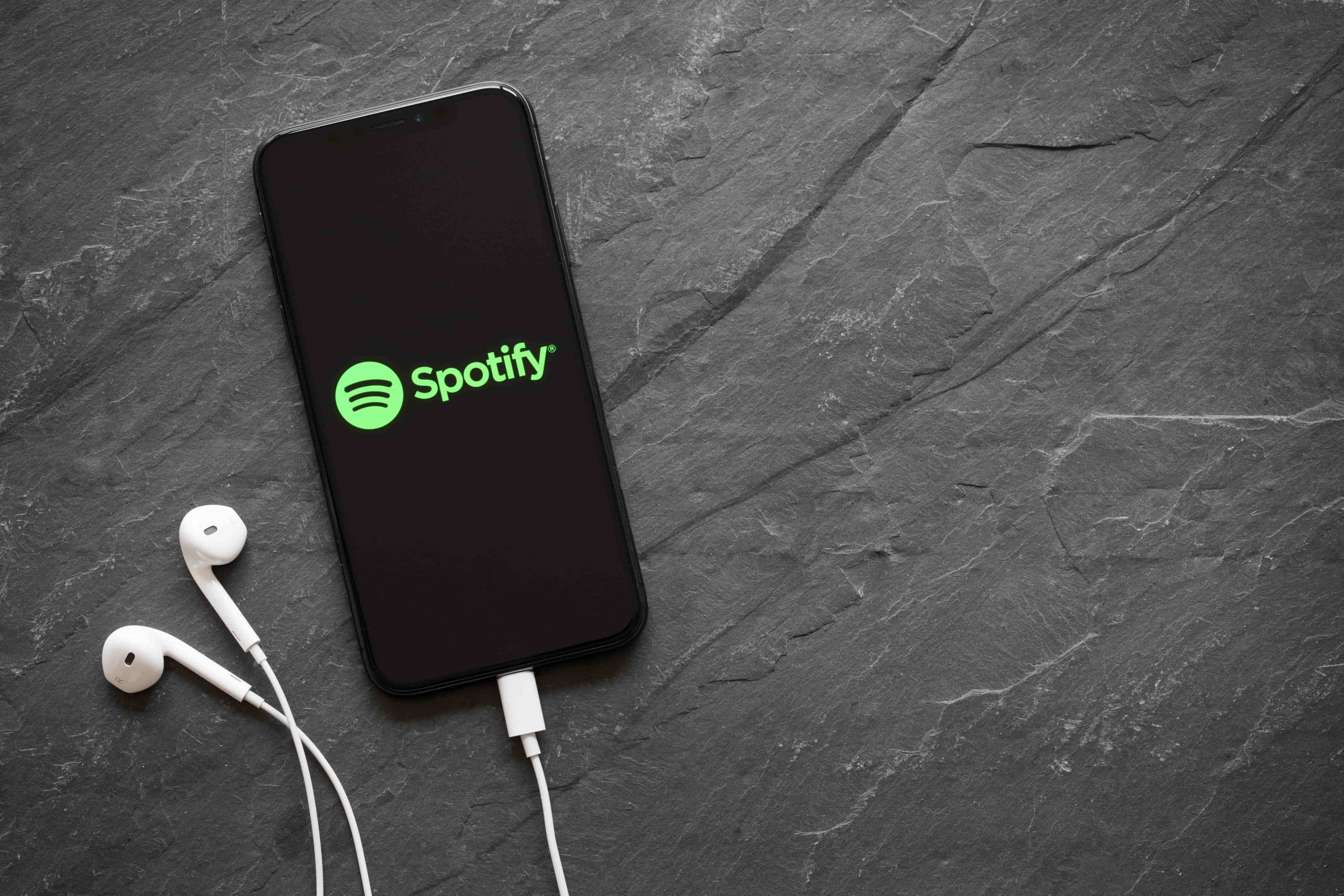 spotify on a phone with earbuds