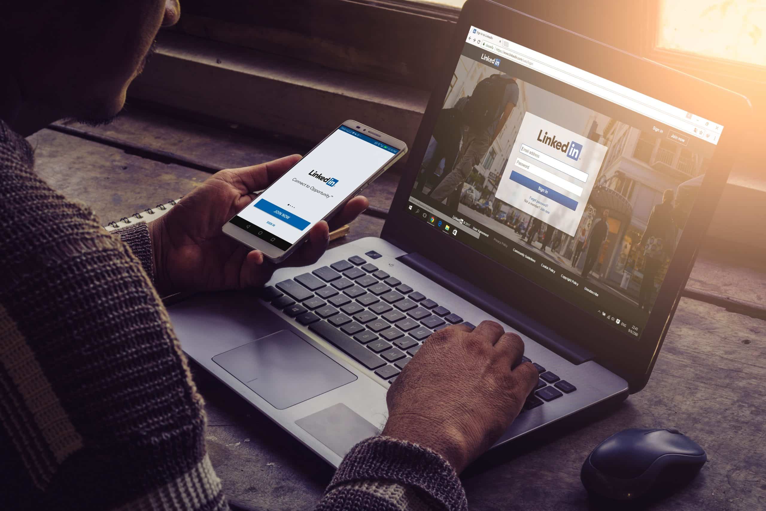 linkedin on a phone and laptop