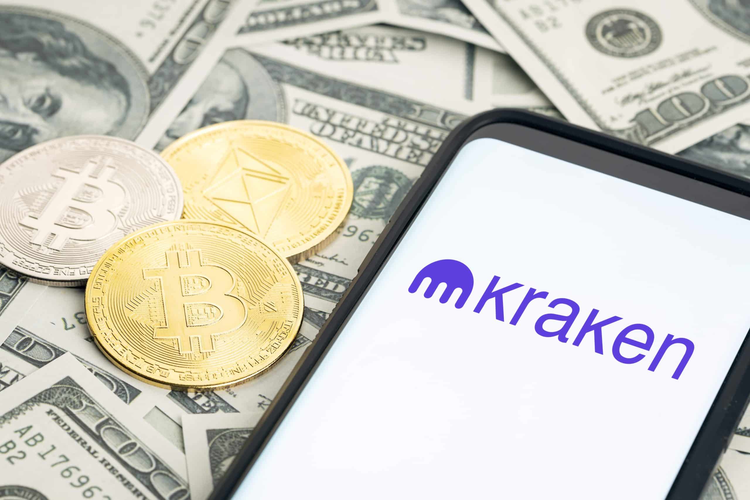 kraken logo on a phone next to money
