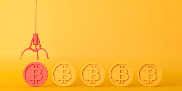 Bitcoin being lifted up from a row of bitcoins