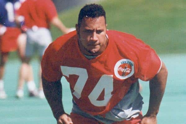 Dwayne Johnson playing football