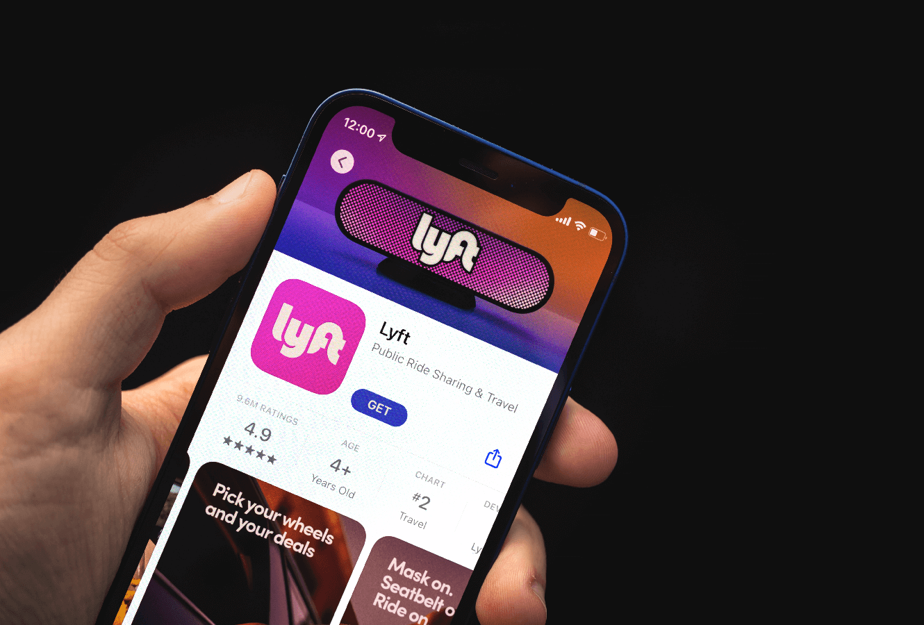 Person holding mobile phone and using Lyft app