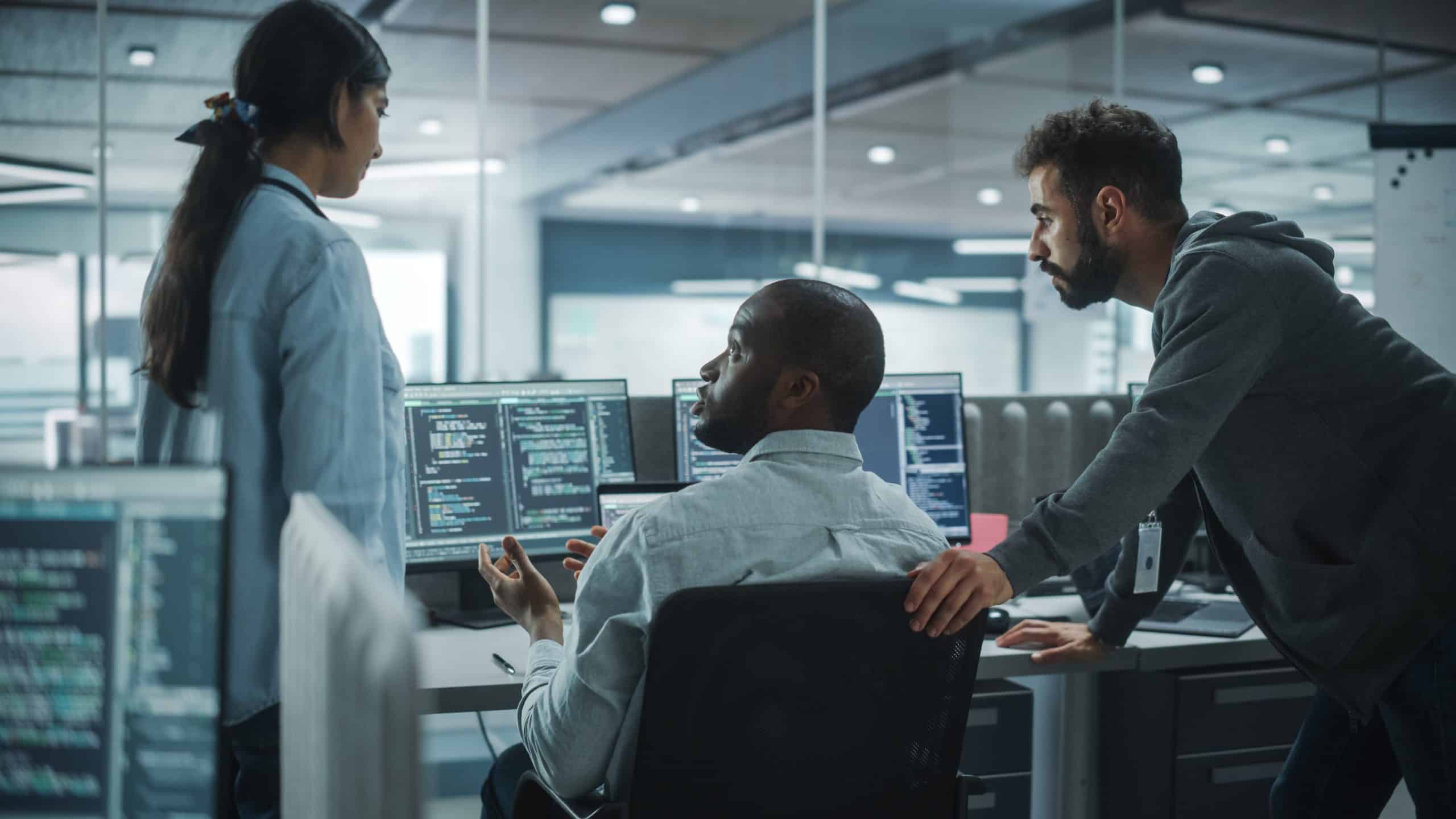 cybersecurity people at a desk looking at computers