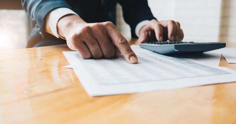 man pointing at balance sheet