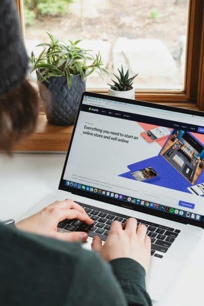 Photo of a laptop with the Shopify landing page on