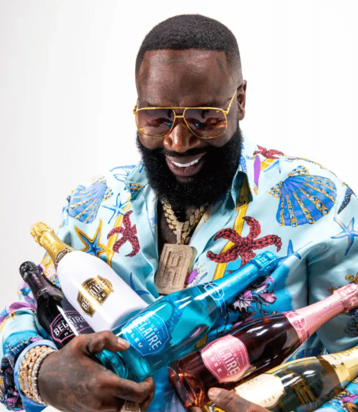 Rick Ross holding alcohol bottles