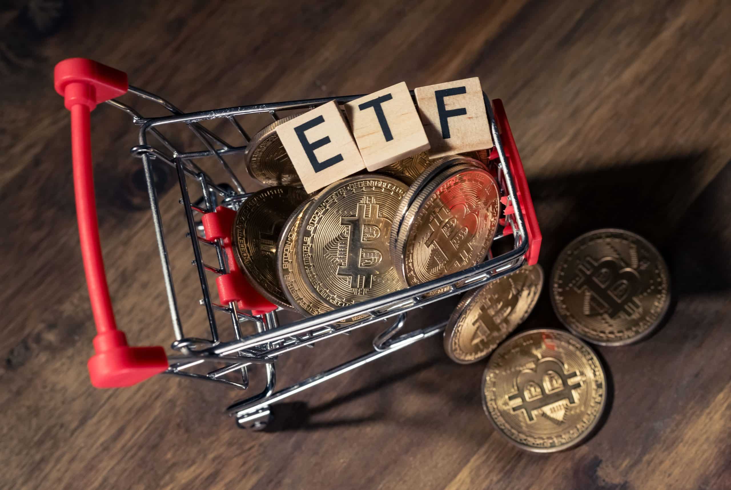 shopping carts of crypto coins and blocks spelling ETF