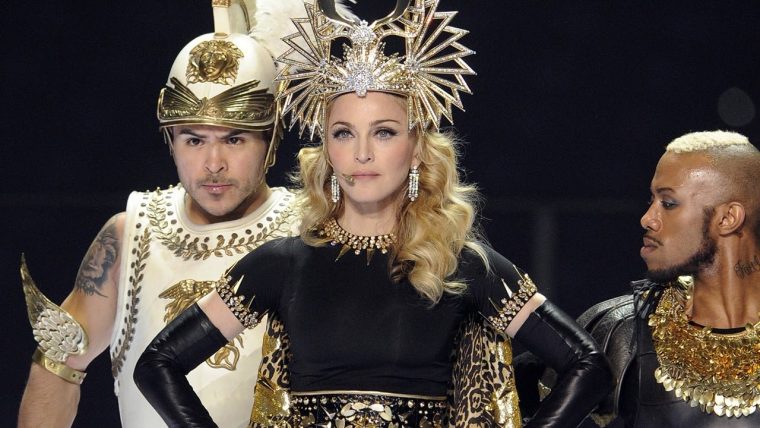 Madonna performing with a weird hat