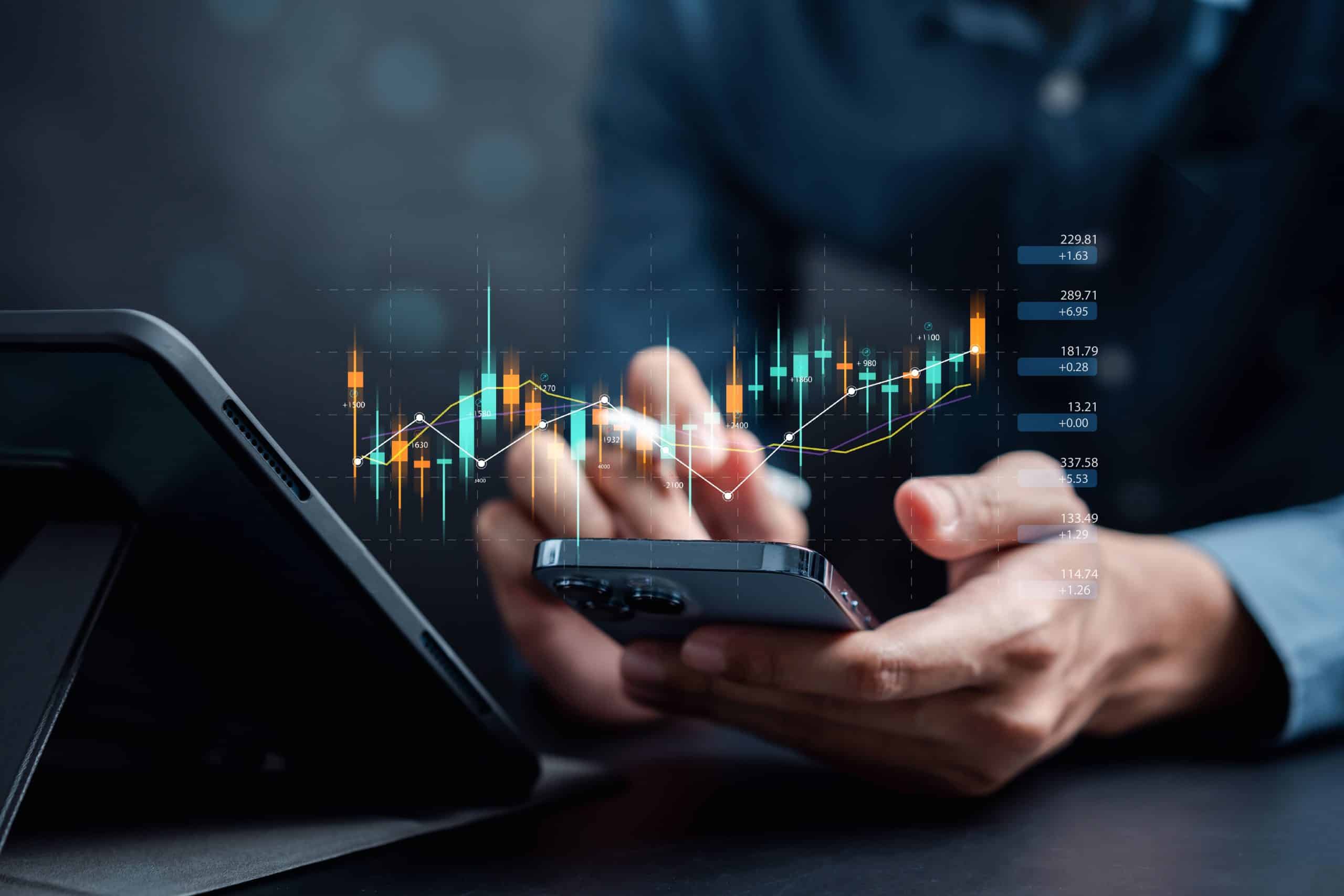 trader with a computer and phone